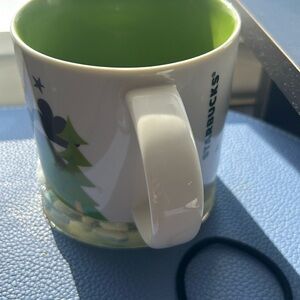 Green jacket, pants, and blue dress